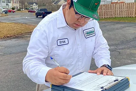 technician filling out paperwork