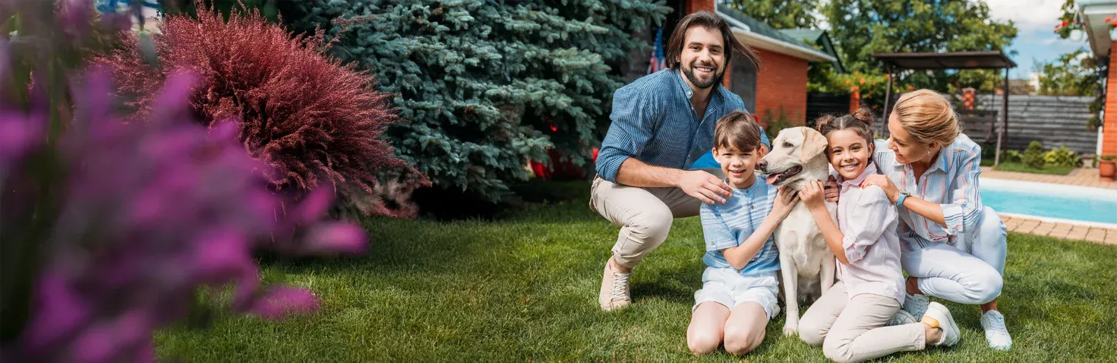 family playing outside with dog