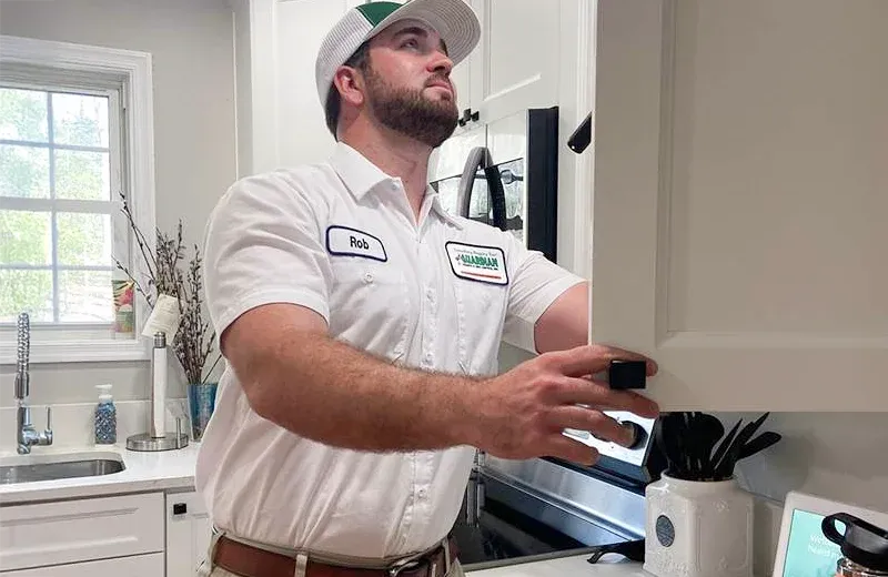 technician inspecting kitchen cabinets